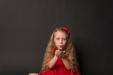 Baby blows tinsel valentine red, flirt board, on the floor hearts married wedding. holiday. event forever, hearts in red dress girl, barefoot