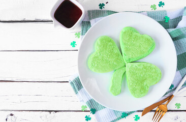 St Patricks Day shamrock pancakes. Top view table scene on a white wood background with copy space.