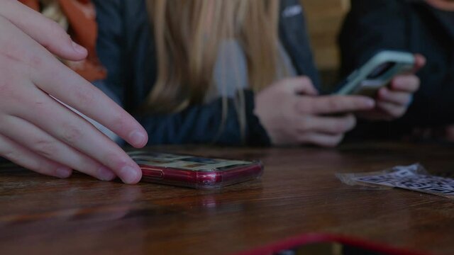 Close up shot of two females interacting on their cell phones