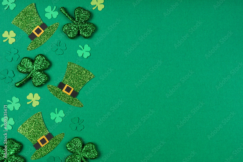 Aufkleber st patricks day shamrock and leprechaun hat side border. top down view over a green paper background