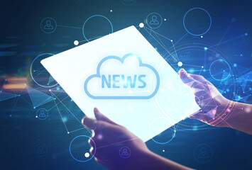 Hand holdig futuristic tablet with NEWS inscription, modern technology concept