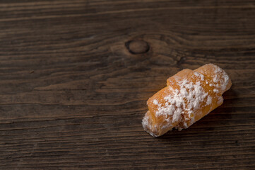 one bagel lies on a wooden board in the corner top view
