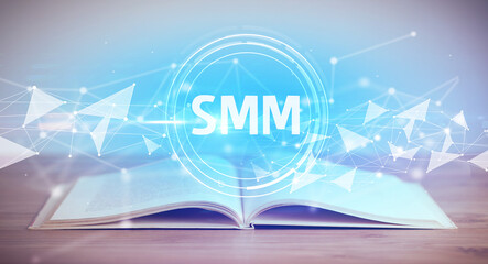 Open book with SMM abbreviation, modern technology concept