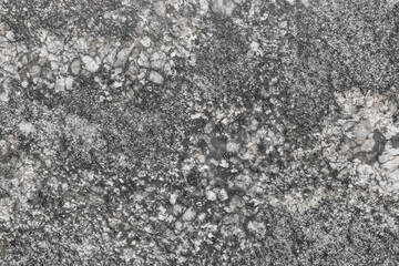 Dark gray stone granite or old marble slab surface with abstract wall texture background