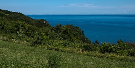 View of the endless sea horizon from the hilly coast. 
