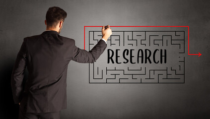 businessman drawing maze with RESEARCH inscription, business education concept