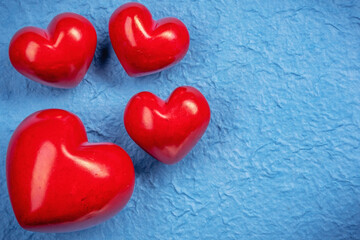 Red stone heart on a blue surface