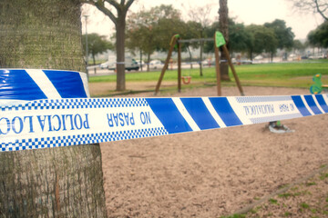 Children's outdoor playgrounds rewound with police tape due to virus.No entry allowed.