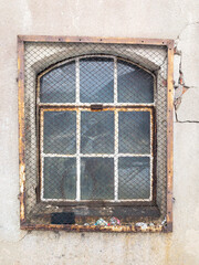 Old metal window in the wall. Rusty 