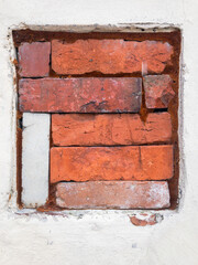 red bricks stack in a old square shape window