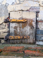 old small wooden door in the wall. Rusty