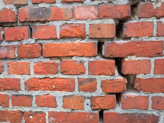 Fototapeta premium Crack in a red brick wall