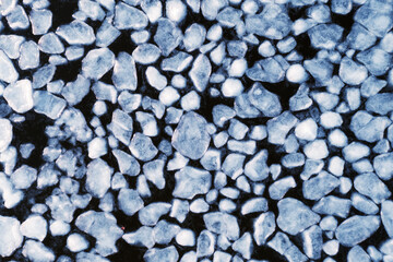 abstract texture of broken white ice and dark blue water. View of the ice from a drone. background of the frozen surface of a clean lake or river