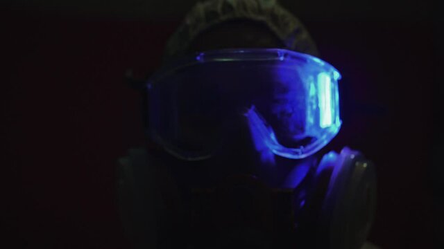 Man in protective costume suit, gas protect medical antibacterial antiviral spray paint mask. Doctor health worker in respirator. Concept health virus coronavirus epidemic. Radiation Nuclear war.