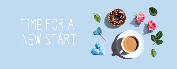 Time for a new start message with a cup of coffee and a donut - flat lay