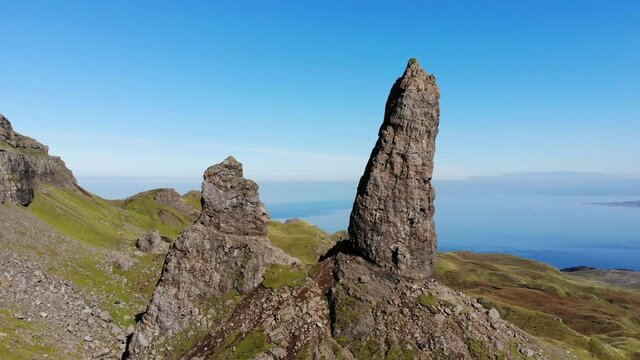 Panning shot at the south side of the Old Man of Storr on the Isle of Skye on a clear sunny day.