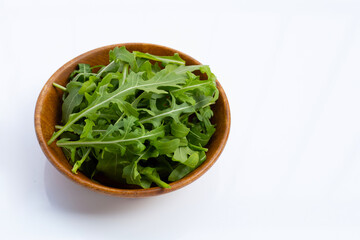 Fresh green rocket salad on white background.