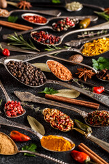 Various spices a vintage spoons on stone table. Colorful Herbal and Spices Oriental marketplace.Top view . Cafe concept. Delicious food delivery.