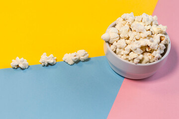 Popcorn bowl on yellow, pink and blue background, popcorn road