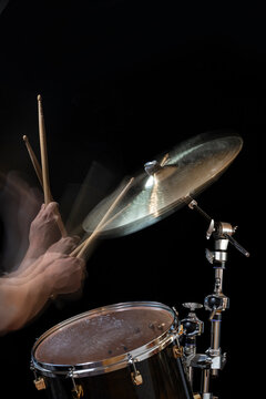 Stroboscopic drummer hitting cymbals with drum sticks