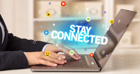 Freelance woman using laptop with STAY CONNECTED inscription, Social media concept