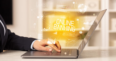 Side view of a business person working on laptop with ONLINE BANKING inscription, modern business concept