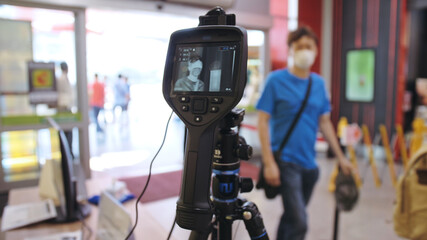 Temperature check at a supermarket, grocery store with thermal imaging camera installed. Image...