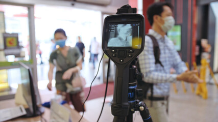 Temperature check at a supermarket, grocery store with a thermal imaging camera installed. Image monitoring scanner to monitor the body temperature of visitor customer. Coronavirus pandemic outbreak.