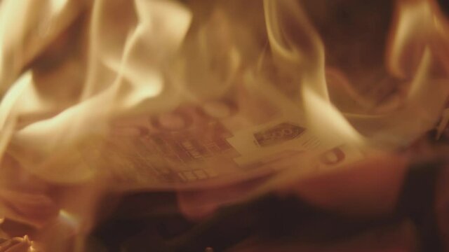 Five Hundred 500 Euros Banknote burning in a flame. Stock market crush concept.