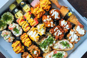 Various kinds of sushi served  on a white background.