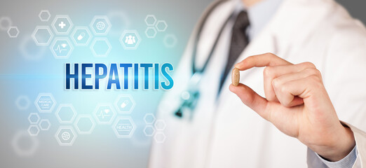 Close-up of a doctor giving you a pill with HEPATITIS inscription, medical concept