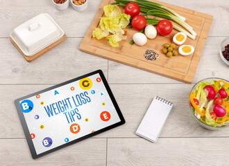 Healthy Tablet Pc compostion with WEIGHT LOSS TIPS inscription, weight loss concept