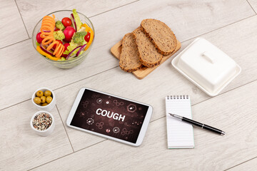 Healthy Tablet Pc compostion with COUGH inscription, immune system boost concept