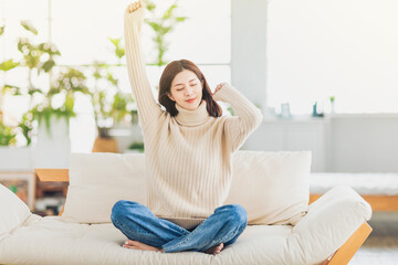 Young woman  sitting on sofa and relaxing in living room