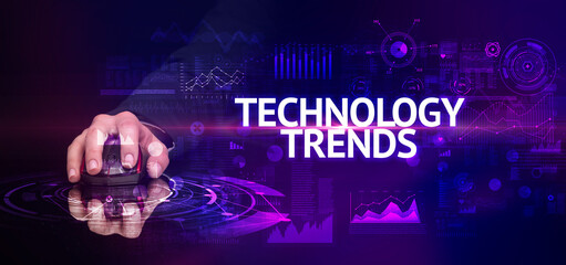 hand holding wireless peripheral with TECHNOLOGY TRENDS inscription, modern technology concept