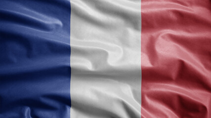 Obraz premium French flag waving in the wind. Close up of France banner blowing, soft silk.