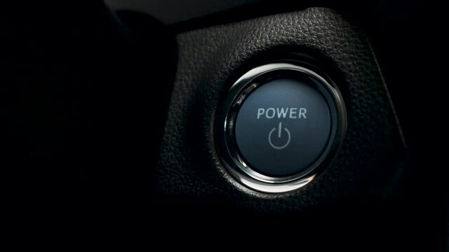 pushing blue Power ignition Button to start keyless ignition hybrid car engine