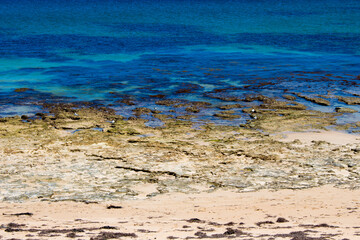 Scenic view of waves rolling in off shore at Ocean Beach Bunbury, Western Australia on a hot summer afternoon creates a splendid seascape with basalt rocks and sandy beaches.