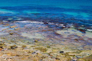 Scenic view of waves rolling in off shore at Ocean Beach Bunbury, Western Australia on a hot summer afternoon creates a splendid seascape with basalt rocks and sandy beaches.