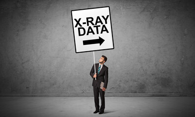 business person holding a traffic sign with X-RAY DATA inscription, new idea concept