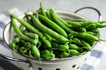 Fresh green beans in colander, closeup view