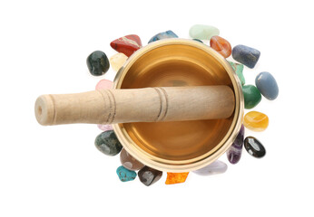 Golden singing bowl with mallet and healing stones on white background, top view