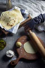 Fototapeta premium Homemade Kulit Kebab or Tortilla wrap on blue white napkin on wooden rustic tray. 