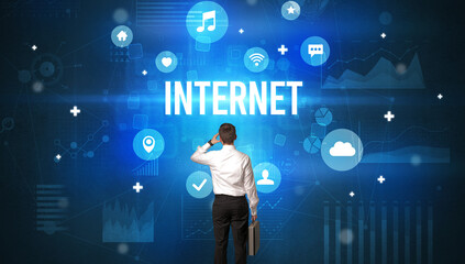 Rear view of a businessman with INTERNET inscription, modern technology concept