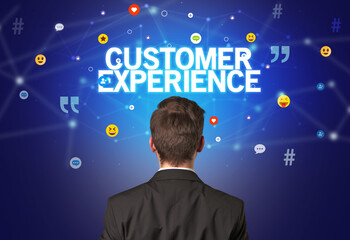 Rear view of a businessman with CUSTOMER EXPERIENCE inscription, social networking concept