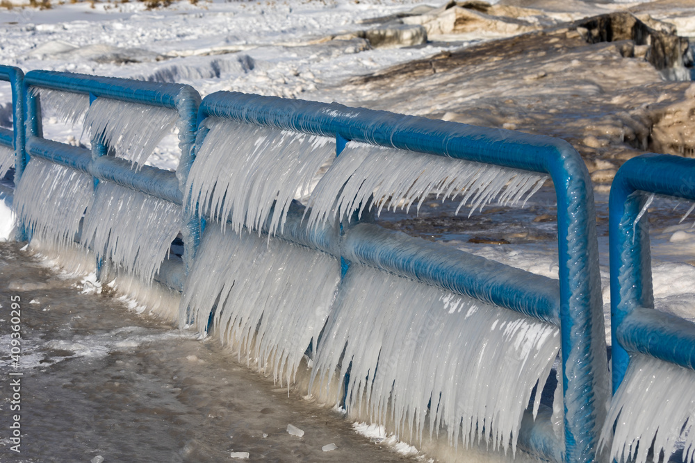 Canvas Prints Ice, water and wind at Lake Michigan form icicles on the railing