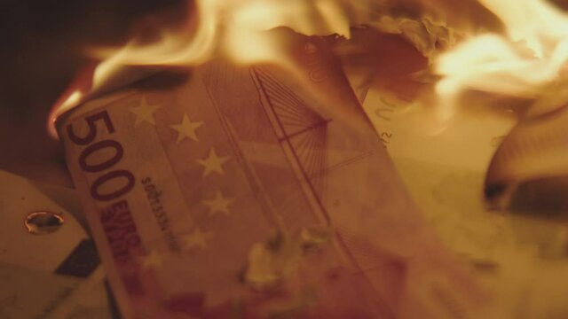 Five Hundred 500 Euros Banknote burning in a flame. Stock market crush concept.