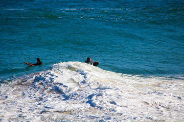 White frothy surfing waves rolling in at Ocean Beach, Bunbury, Western Australia on a fine sunny winter afternoon are inviting to intrepid surfers seeking exciting exercise.