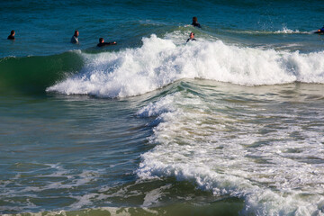 White frothy surfing waves rolling in at Ocean Beach, Bunbury, Western Australia on a fine sunny winter afternoon are inviting to intrepid surfers seeking exciting exercise.