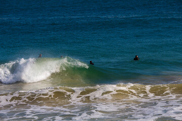 White frothy surfing waves rolling in at Ocean Beach, Bunbury, Western Australia on a fine sunny winter afternoon are inviting to intrepid surfers seeking exciting exercise.